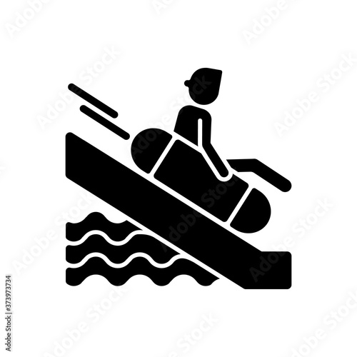 Sliding on swim circle black glyph icon. Water park attraction silhouette symbol on white space. Active summer recreation, aqua park entertainment. Tourist on waterslide vector isolated illustration