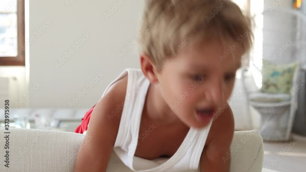 Bored child at home during quarantine. Kid bore with nothing to do during covid Bored child at home during quarantine. Kid bore with nothing to do during covid