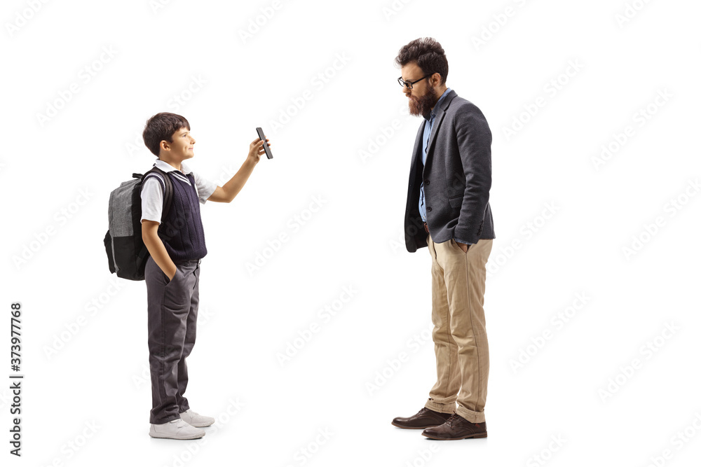 Schoolboy showing a mobile phone to his father