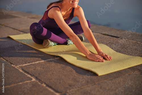 Young smiling woman doing the morning yoga class
