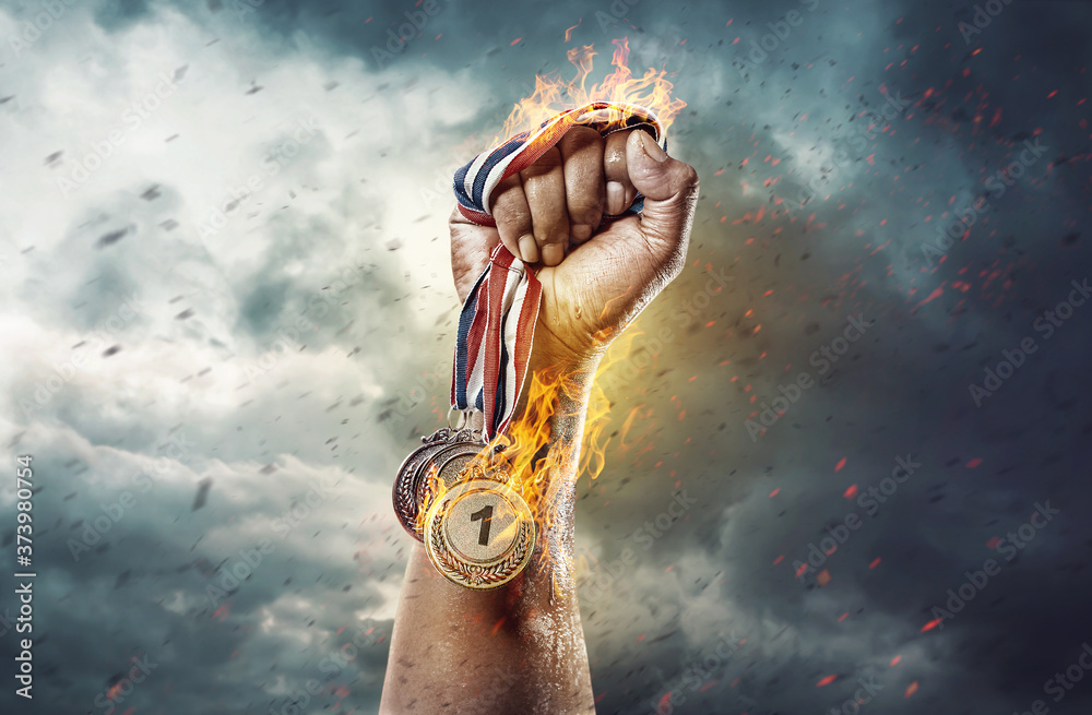 Medal for the first place on sky background. Victory concept. Fire and