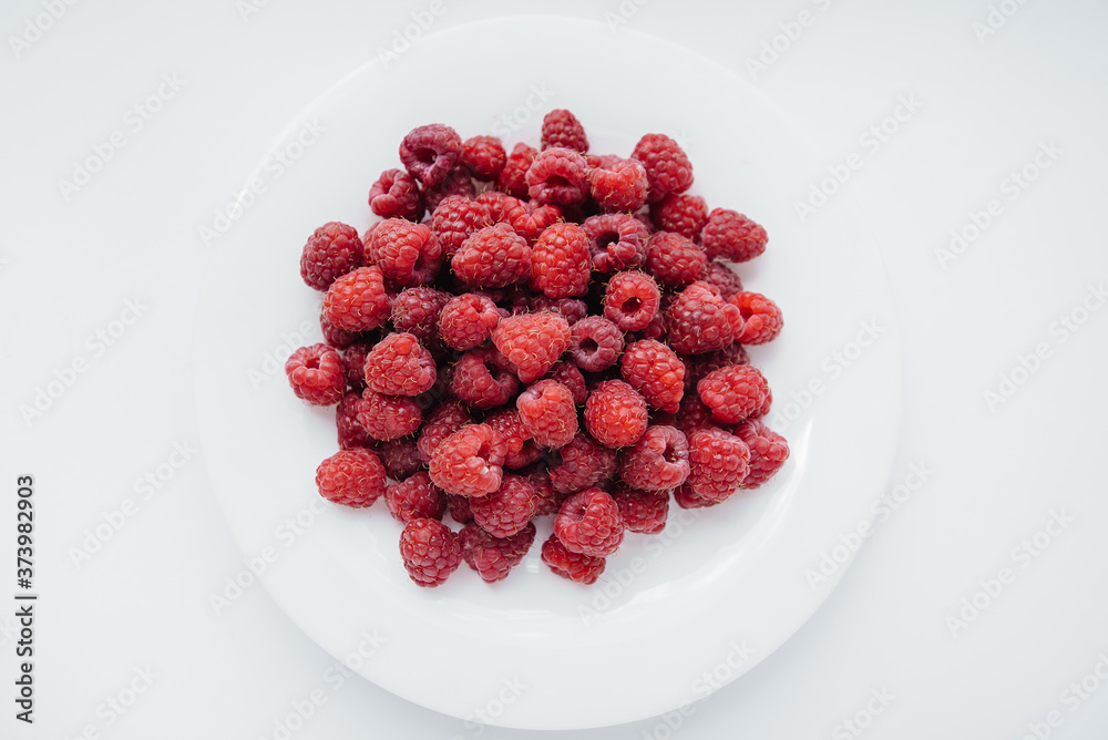 Red raspberry berries close-up on a white background. Healthy food, natural vitamins. Fresh berries