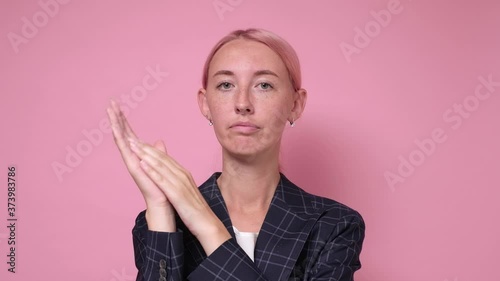 woman is jealous of her colleague success and claps hands with a displeased face and congratulates him. photo