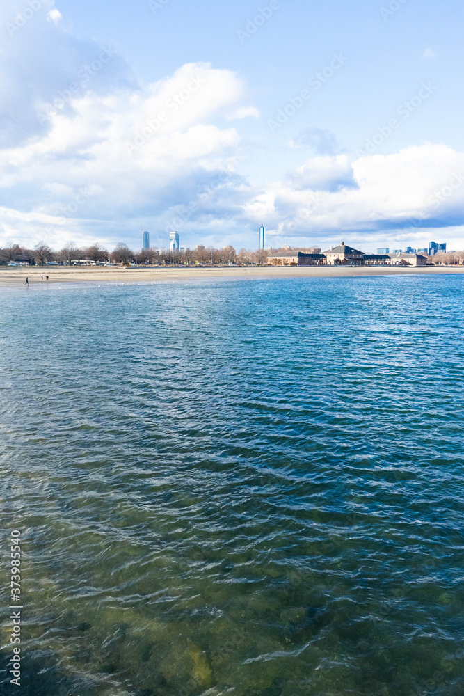 Fototapeta premium Boston skyline vertical view from the harbor point ocean waters showing the city behind