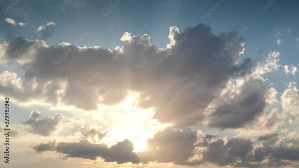 Timelapse footage of clouds with rays of sunlight in the sky