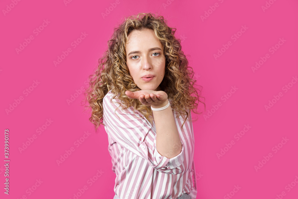 Beautiful woman with makeup and long blonde hair blows a kiss, demonstrates her good feelings, says goodbye from a distance. Beautiful woman with makeup and long blonde hair blows a kiss, demonstrates her good feelings, says goodbye from a distance.
