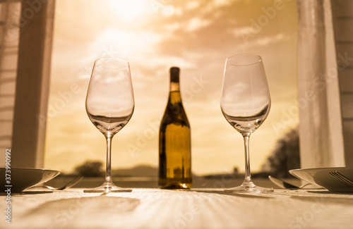 table setting at restaurant with wine and sunset view