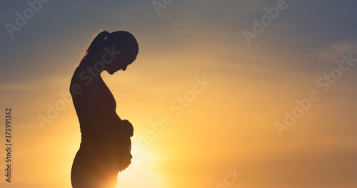 silhouette of happy pregnant woman