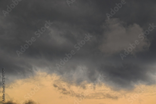 stormy clouds in varying shades of gray, floating under the dusk sky.