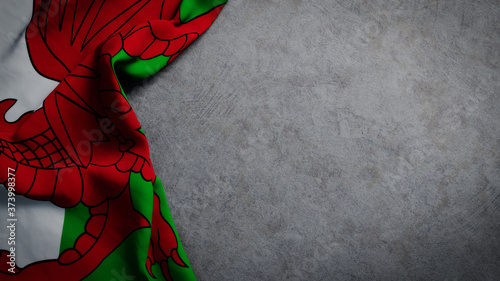 Flag of Wales on concrete backdrop. Welsh flag background with copy space photo