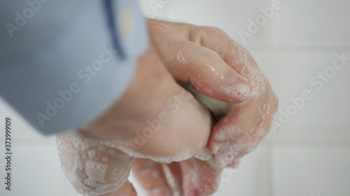 Image with a Person Washing His Hands with Soap and Water