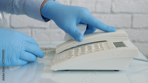 Image with Businessman Hands Wearing Protective Gloves Using Telephone