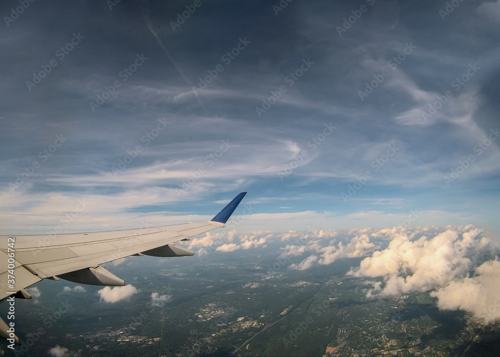 Obraz premium Aerial view of cloud and sky with airplane wing from window