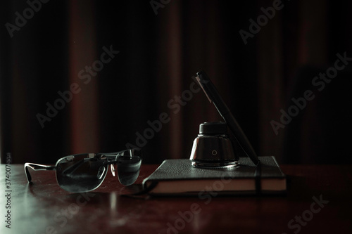 Vintage looking photo of a various items placed over a journal on a table top