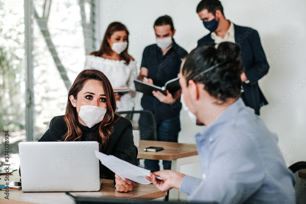 latin people teamwork with face mask at office or workplace in Mexico pandemic coronavirus latin people teamwork with face mask at office or workplace in Mexico pandemic coronavirus