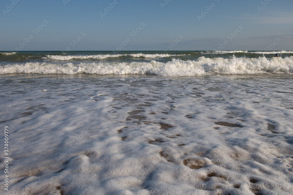 Foamy shore. Tidal bore. Beach. Boring sea. Foamy shore. Tidal bore. Beach. Boring sea.