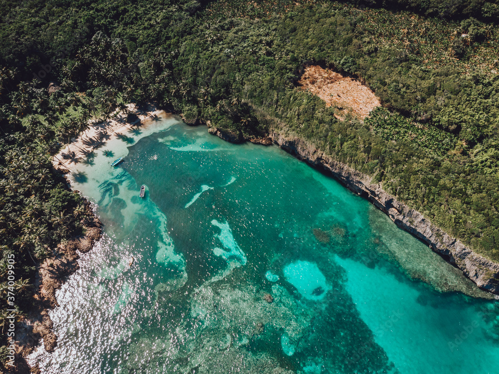 Aerial drone view of intimate paradise beach with blue lagoon and palm trees at the Madama beach, Samana, Dominican Republic