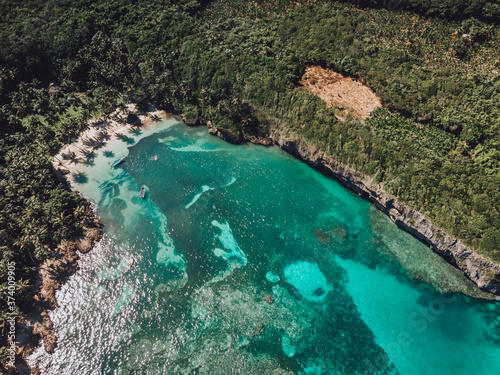 Aerial drone view of intimate paradise beach with blue lagoon and palm trees at the Madama beach, Samana, Dominican Republic