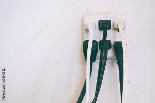 Φωτογραφία Electrical cables plugged into wall outlet.