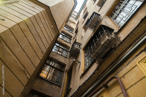 The courtyard of an old apartment building in St. Petersburg with yellow shabby walls