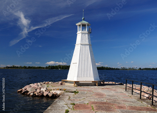 Small White Lighthouse At Vattern Lake in Vadstena On A Sunny Summer Day With A Clear Blue Sky photo