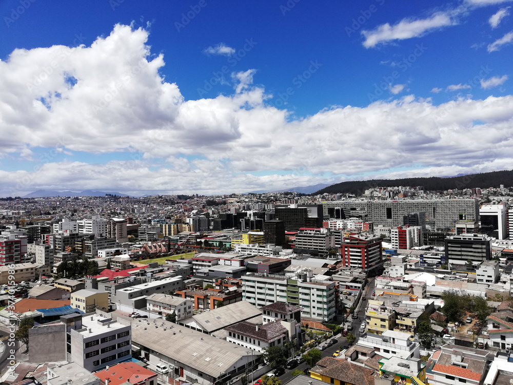 View from the top of the north of the city of Quito, you can see buildings, mountains, the sky and clouds