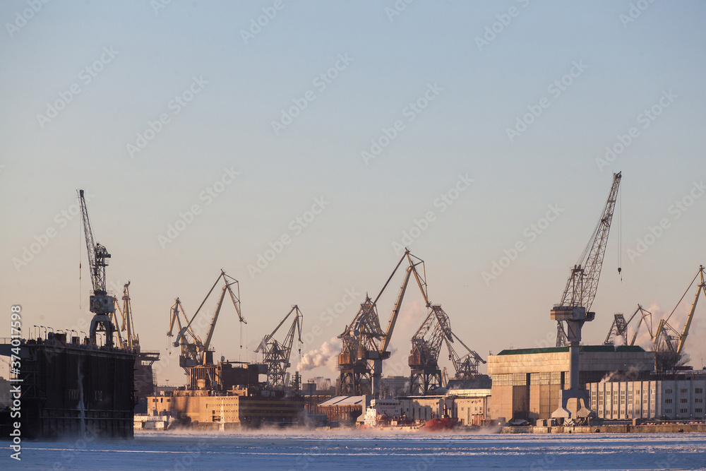 Large industrial cranes of the admiralty shipyards in saint petersburg in winter
