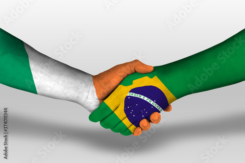 Handshake between brazil and ireland flags painted on hands, illustration with clipping path. photo