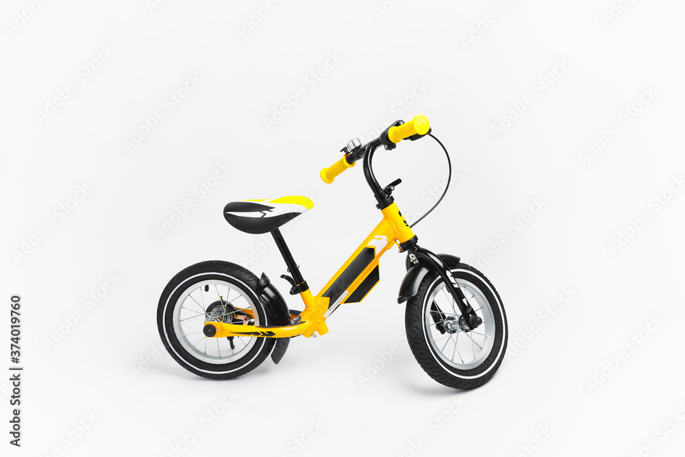 yellow balance bike on white background