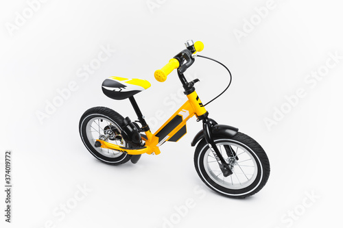 yellow balance bike on white background