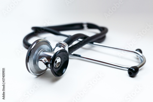 Black Stethoscope and phonendoscope isolated on white close up. Selective focus. Medical concept.  photo