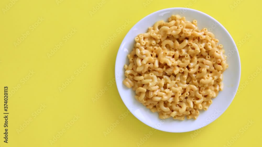 Serving Macaroni and Cheese on a Yellow Background