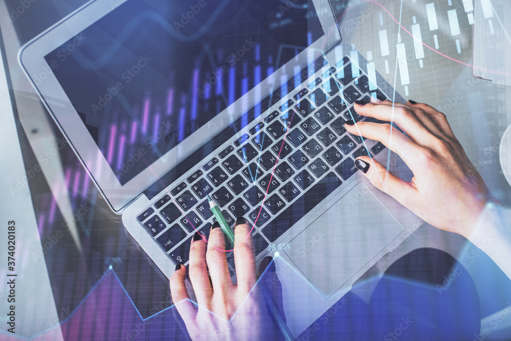 Double exposure of woman hands working on computer and forex chart hologram drawing. Top View. Financial analysis concept. Double exposure of woman hands working on computer and forex chart hologram drawing. Top View. Financial analysis concept.