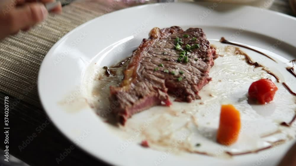 Close-up hands cutting pieace of meat steak Close-up hands cutting pieace of meat steak