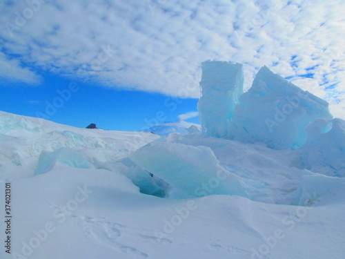 Pressure Ridges near McMurdo Station, Antarctica, Blue Ice with Castle Rock and Mount Erebus in background photo