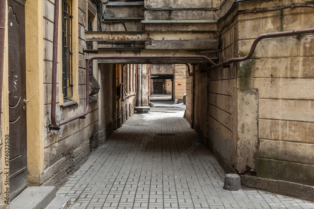 Arch in the entrance courtyard of an old apartment building in St. Petersburg