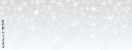 Christmas background of falling snowflakes in gray colors