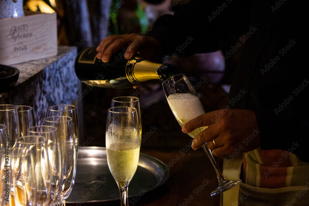 Pouring sparkling wine into a glass in a restaurant