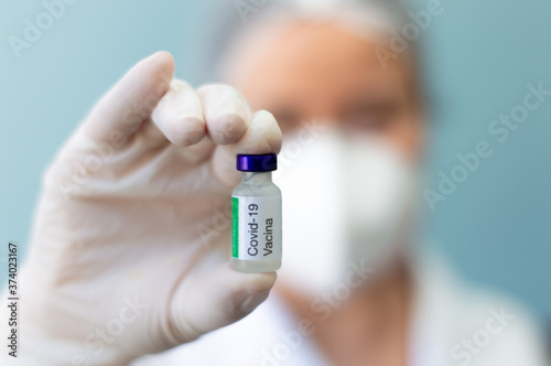Scientist holding covid vaccine bottle 