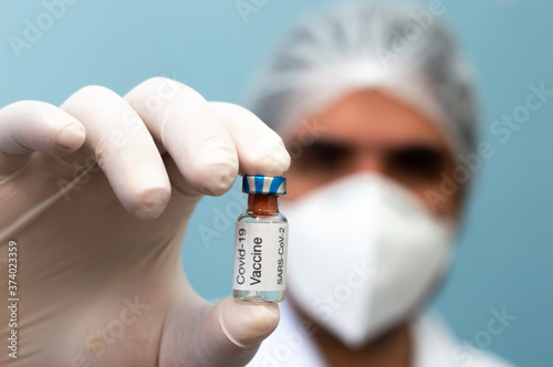 Scientist holding covid vaccine bottle