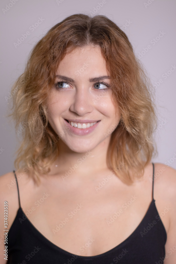 emotional portrait of a beautiful curly blonde-redhead in black undershirt. High quality photo emotional portrait of a beautiful curly blonde-redhead in black undershirt. High quality photo