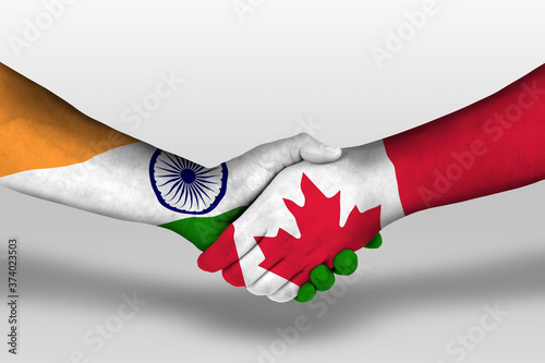 Handshake between canada and india flags painted on hands, illustration with clipping path. photo