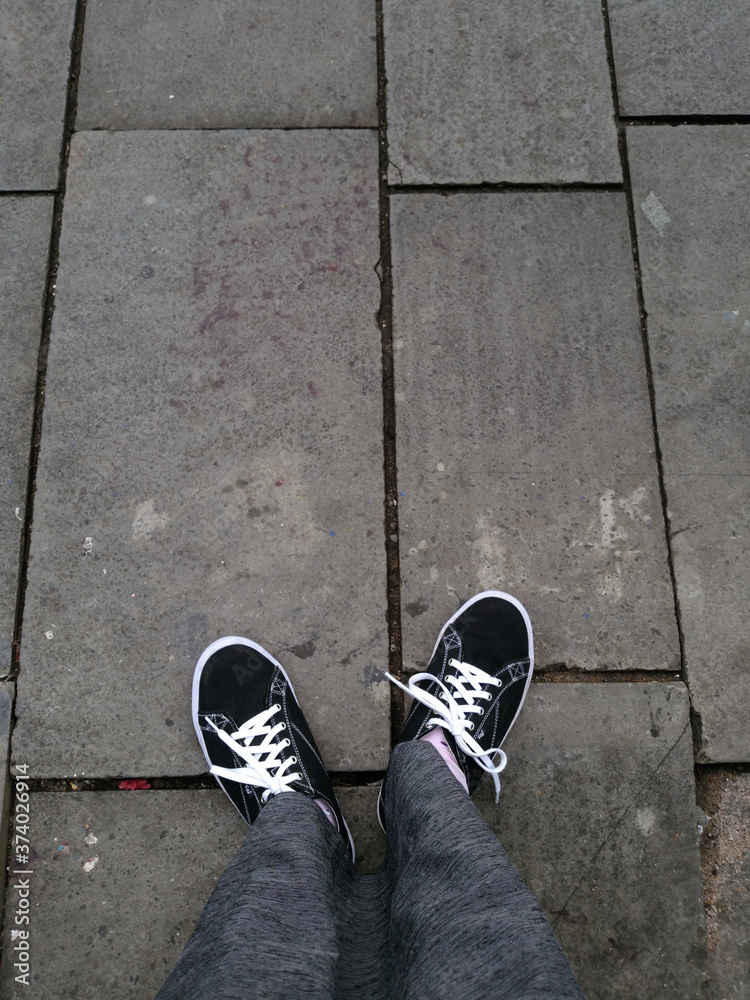 feet on the pavement wear black shoes