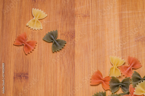 Fototapeta Naklejka Na Ścianę i Meble -  fresh pasta flower shaped on wood background