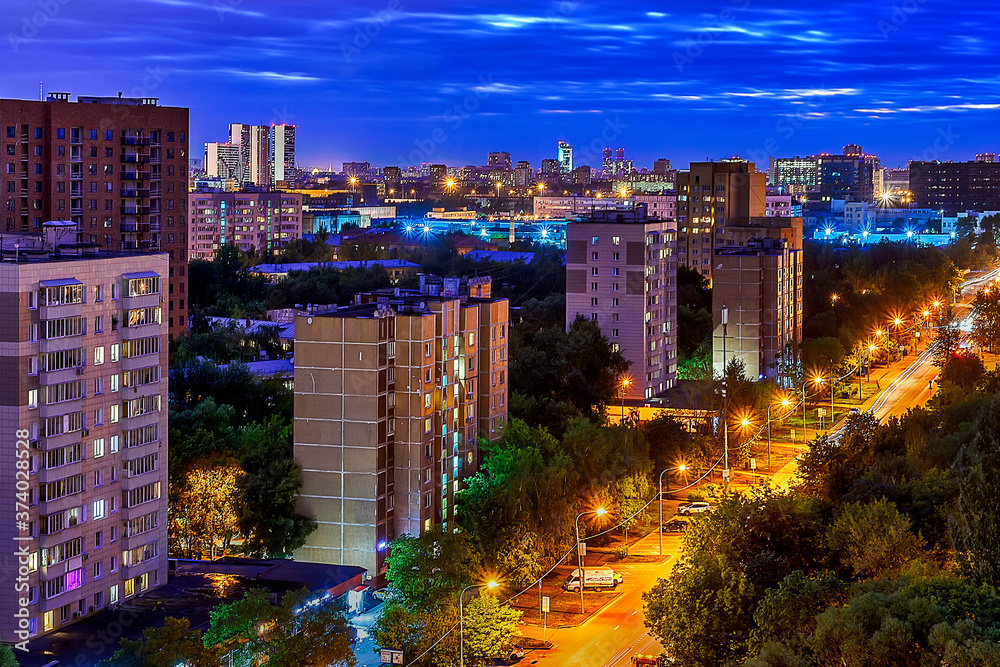 Obraz premium Night street in lights with blue sky and yellow road
