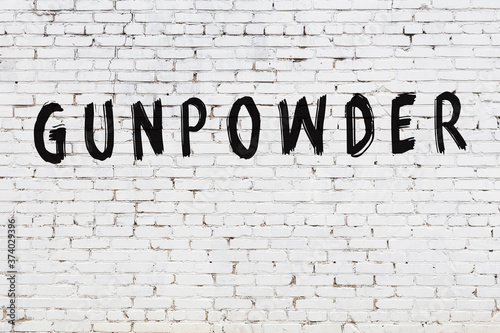 Inscription gunpowder painted on white brick wall
