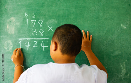 Students doing math exercises on the blackboard