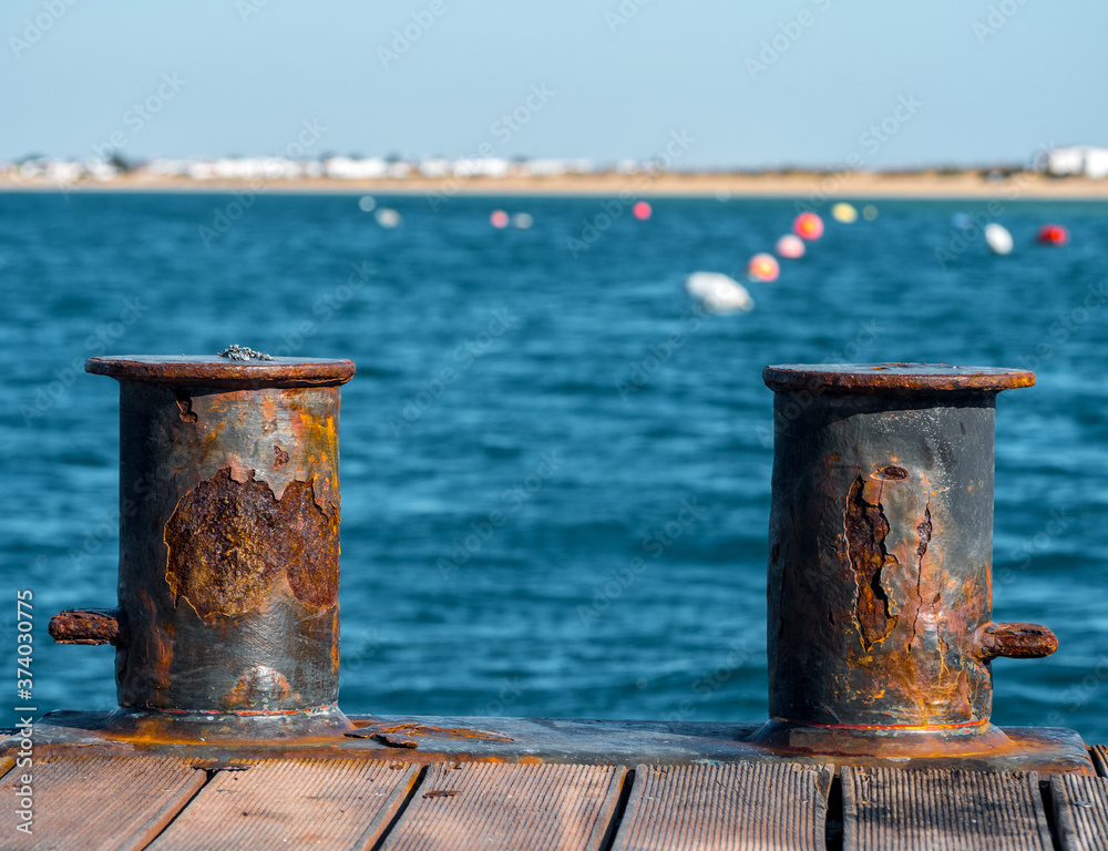 Close of two rusty bollards in the pier