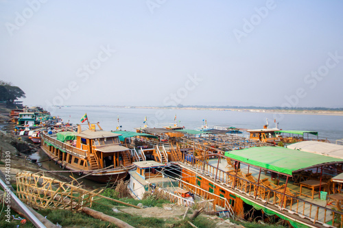 Big river tour and local traditional boats in rural area, Myanmar, Burma