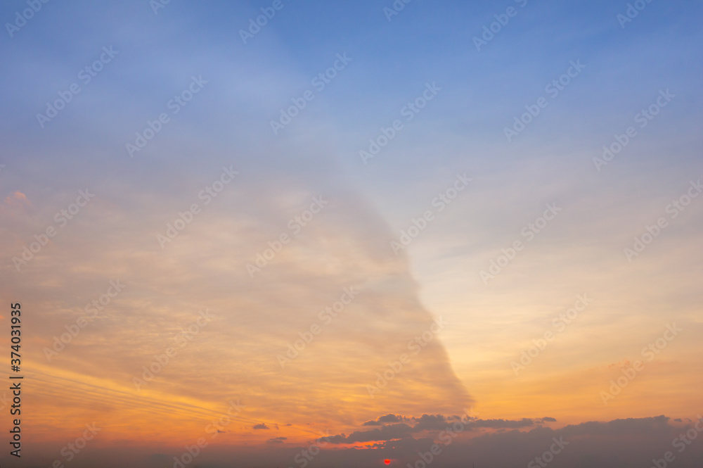 Beautiful Vivid sky painted by the sun leaving bright golden shades.Dense clouds in twilight sky in winter evening.Image of cloud sky on evening time.Evening Vivid  sky with clouds.